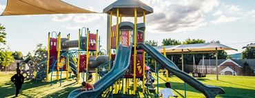 commercial playground installation with sun shade