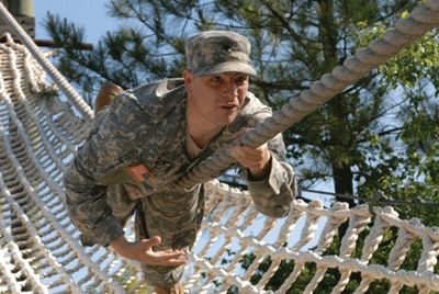 Soldier participating in military training program obstacle course.