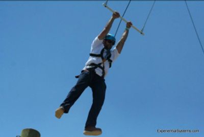 Ropes course participant on Pamper Leap activity at an adventure course in Missouri.