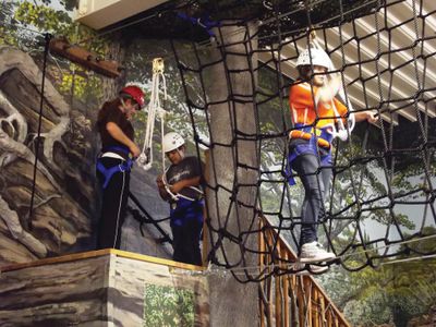Young people doing team building activity on an indoor ropes course in Illinois.