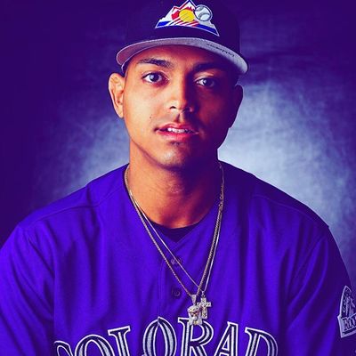 Young man in a Colorado Rockies baseball jersey and cap.