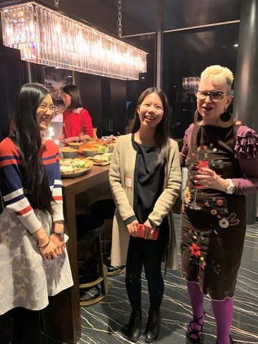 Leslie Wolf-Creutzfeldt, CUSWF executive director greeting, Wellesley alum at Lunar New Year party.