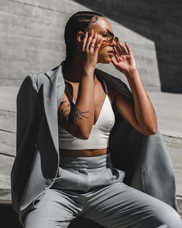 Girl posing in suit and sunglasses