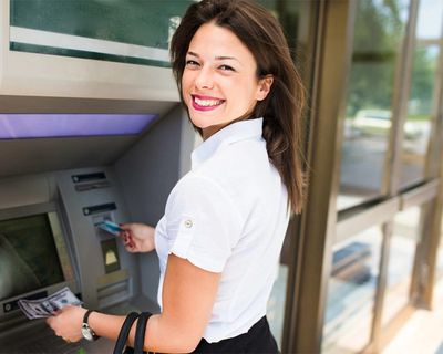 A lady happy to use an ATM