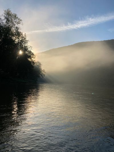 sun mountain fog foggy calm river water