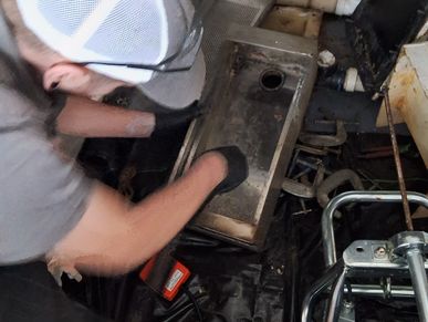 man cleaning a residential grease trap
