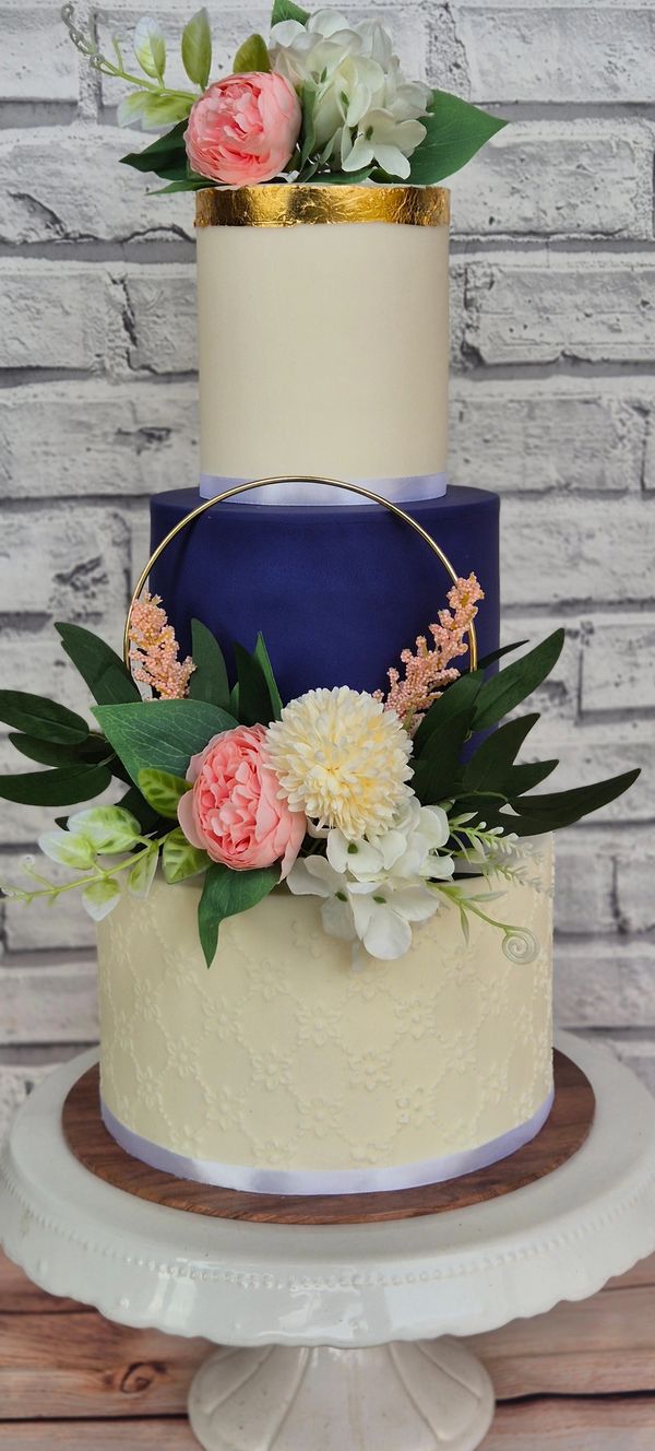 3 tier wedding cake with one Navy tier, and gold accents