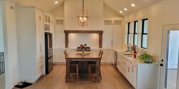 Modern farmhouse kitchen with white cabinets and wooden island.