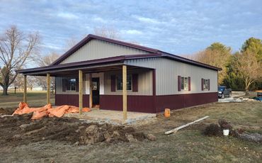 Tan and burgundy addition with a new covered front porch