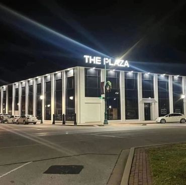Two-story downtown commercial building lit up at night