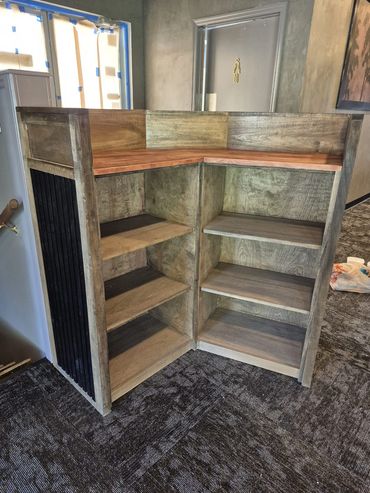 Rustic wood corner shelving unit with corrugated metal panels