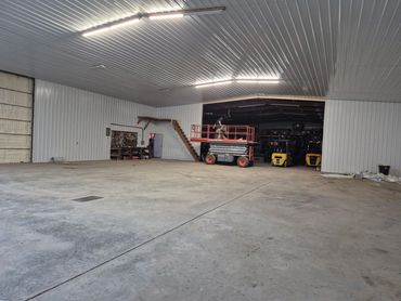 Finished shop interior with white steel liner, LED lights and a concrete floor