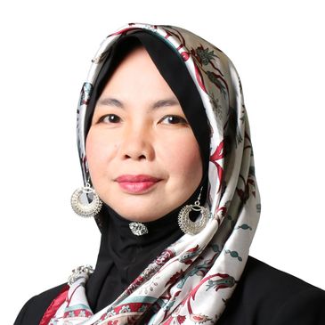 A photo of Wan Fara with a head scarf on and silver earrings.