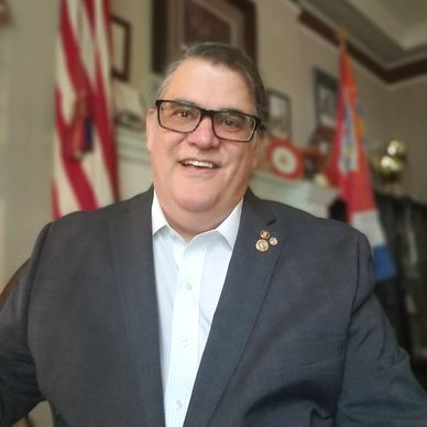 Marti Mongiello shown hiking with a woodland background.