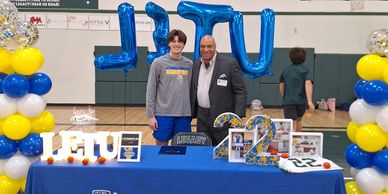 Student and coach at Keith Coleman Academy celebration with university-themed decor.