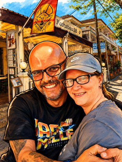 A happy couple embracing outside Fuchsbau 26 on a sunny day.