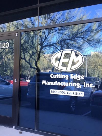 Glass front door saying "CEM" in oval with Cutting Edge Manufacturing, Inc. and ISO 9001 Certified. 