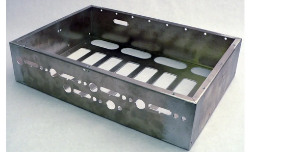 A box made of sheet metal with various holes laser cut in the sides. 