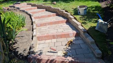 Red and white paving blocks installed in garden
