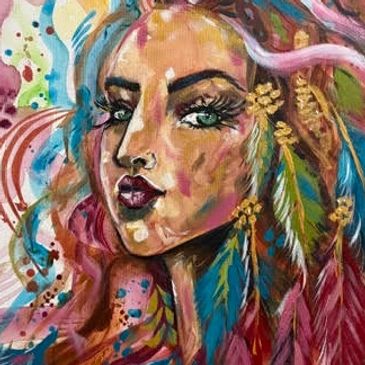 Colorful portrait of a woman with vibrant feathers in her hair.