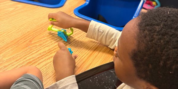 Child playing working on arts and crafts in Rising Star Child Care center.
