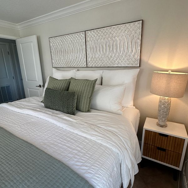 Image of a bedroom with lovely bedding and decor.