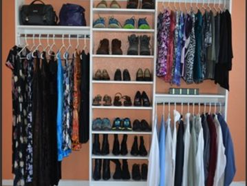 Organized closet with dresses, shoes, and shirts neatly arranged.