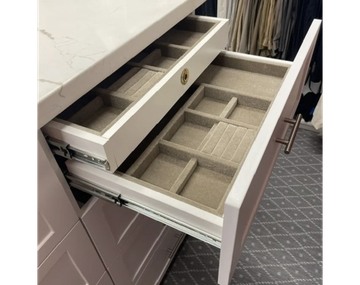 Open drawer with neatly divided compartments.