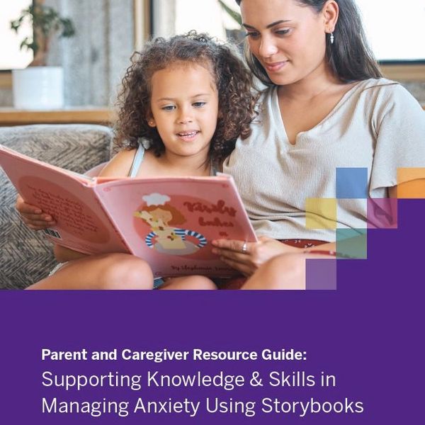 Mother reading a storybook to her daughter to manage anxiety.