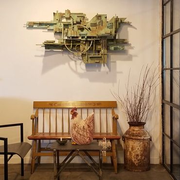 Cozy industrial space with vintage furniture and art.