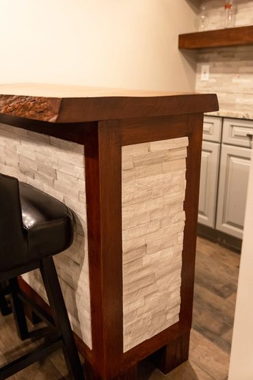 Built-in bar with stone tile backsplash and porcelain tile floor installation