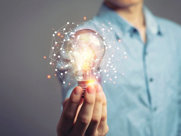 Man holding light bulbs, ideas of new ideas with innovative technology and creativity.