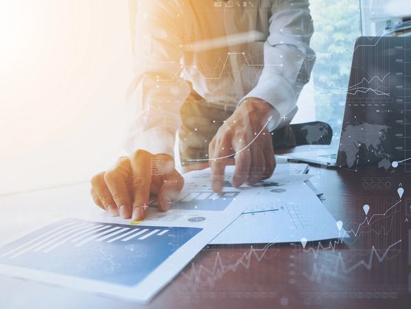 man looking at graphs on paper