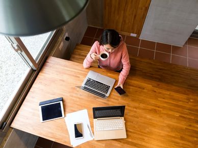 Top view of woman drinking of coffee with checking the message on cellphone