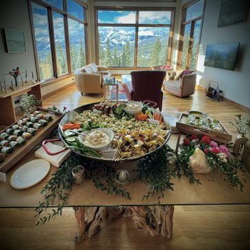 Table with appetizers and a scenic mountain view.