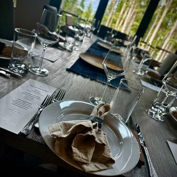 Elegant dining table set with plates, glasses, and napkins.