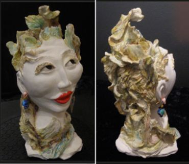 Front and back view of a sculpted clay head of a sun goddess