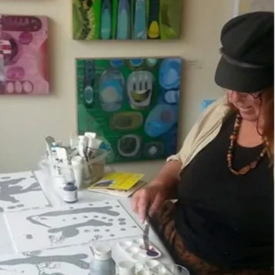 Image of Kathie mixing paint in her studio