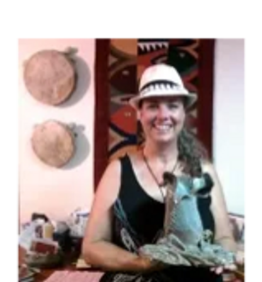 A woman holding a piece of clay artwork made by Kathie