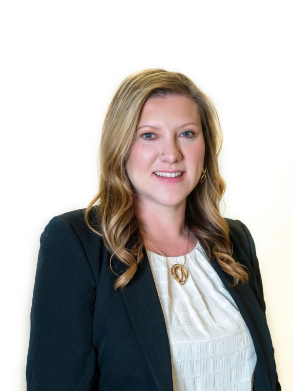 Professional woman in business attire smiling.