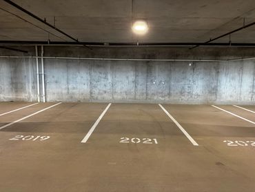 Striping stalls and numbers for a parking garage in American Fork, UT.