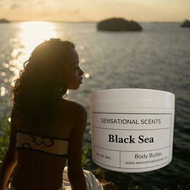 Woman enjoying sunset by the sea with Sensational Scents Black Sea body butter.