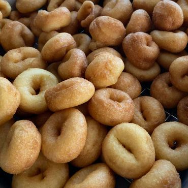 Close-up of freshly fried mini donuts with golden brown crust.