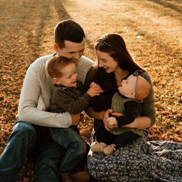A happy family enjoying a moment together outdoors in autumn.