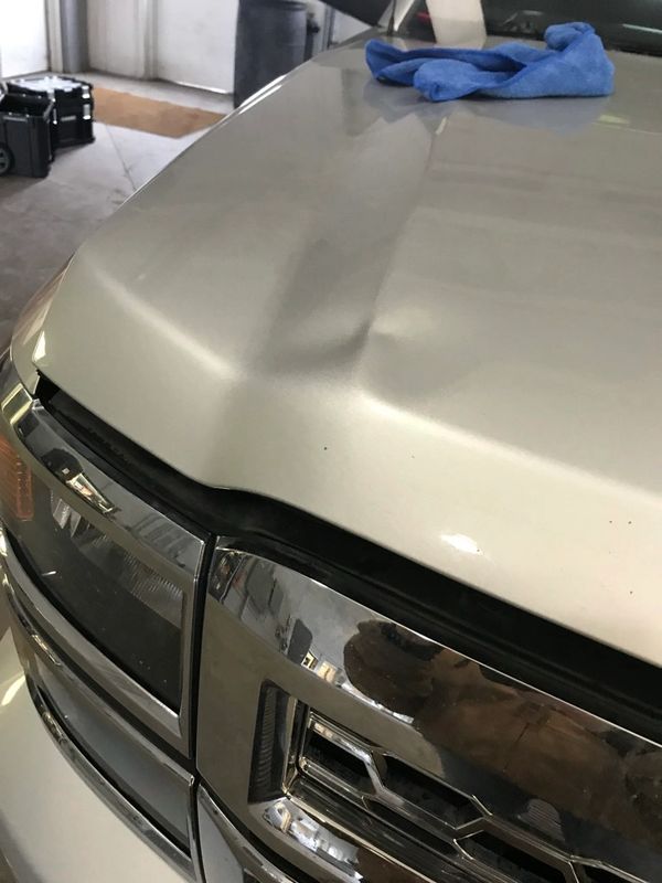 Big dent on chevy silverado hood.