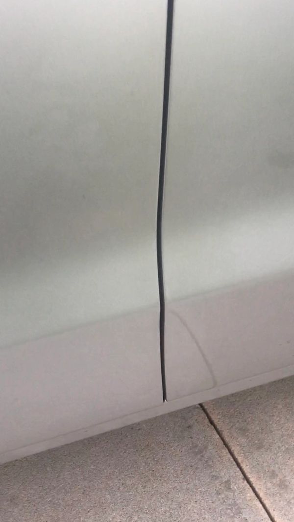 The after photo of the dent on the edge of a door