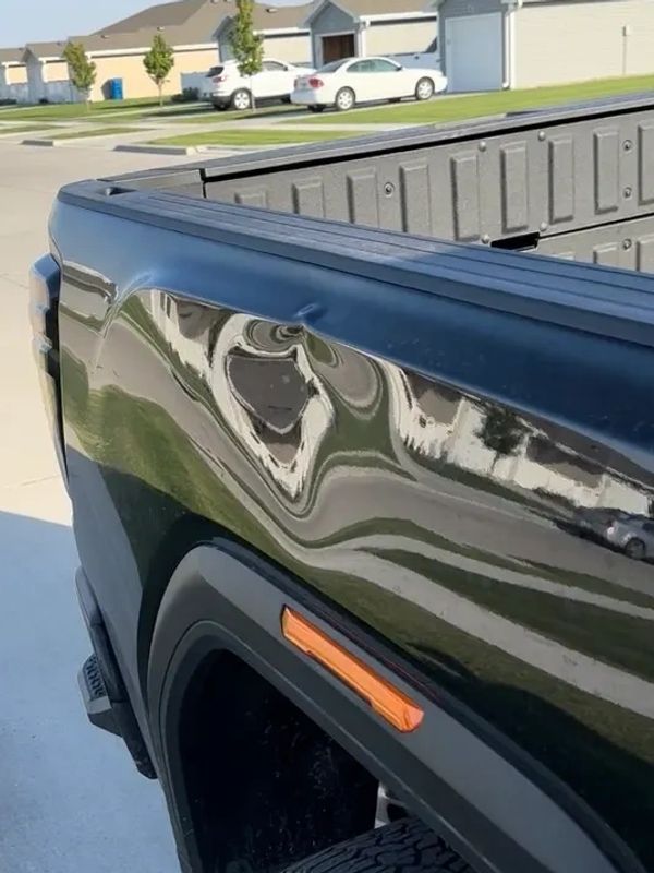 Before Paintless Dent Repair. Big dent On Right Box Side Of GMC Sierra AT4