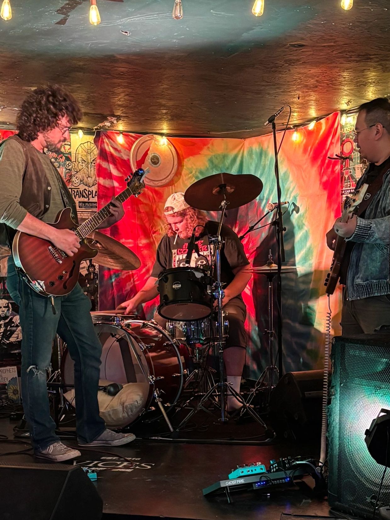 Band playing live in a cozy, dimly lit venue.