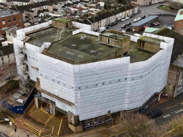Building covered by scaffolders all around