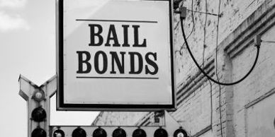 Black and white bail bonds sign on a building.